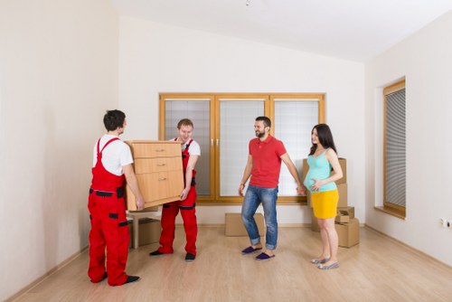 Professional movers handling boxes safely in a Barnet property