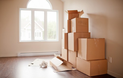 Barnet removal team packing fragile household items with care