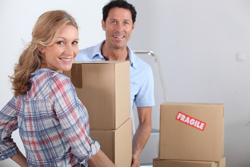 Piano movers in Barnet protecting floors and doorways during a house move