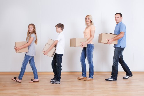 Team carrying a sofa through a Barnet property during furniture pick-up